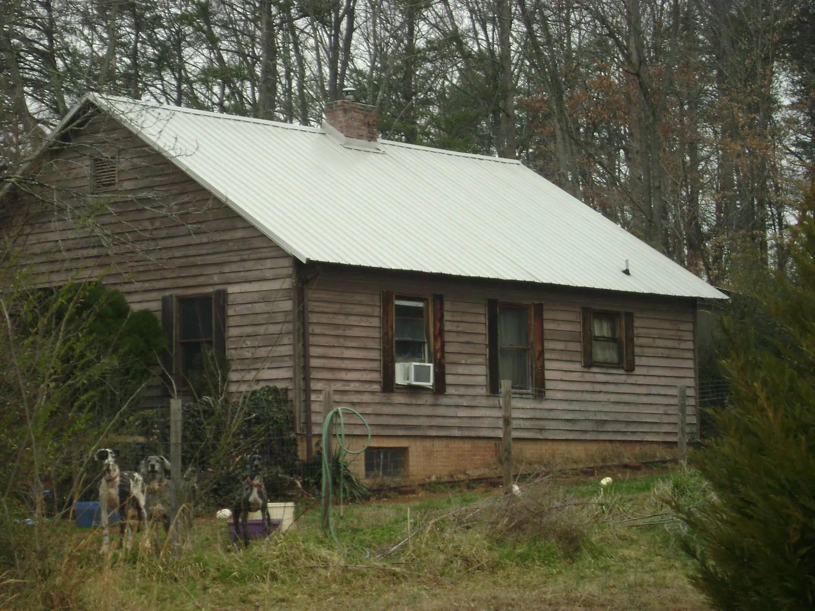 White metal roof on an old wood sided farmhouse, from a Metal Roof Installation job in Mohegan Lake